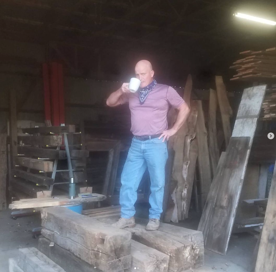 Jim drinking his morning cup of coffee inside the Michigan Reclaimed Barns shop.